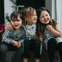 Children laughing and hugging.